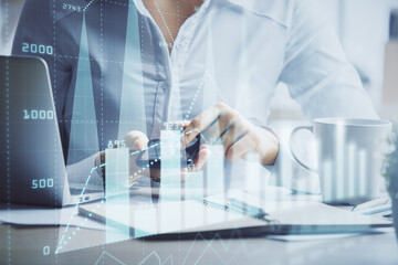 Double exposure of forex chart sketch hologram and woman holding and using a mobile device. Financial market concept.