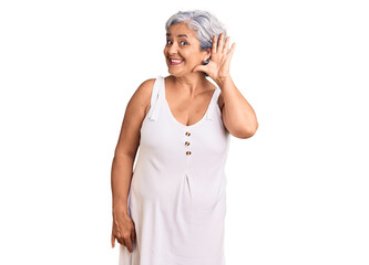 Senior woman with gray hair wearing casual clothes smiling with hand over ear listening an hearing to rumor or gossip. deafness concept.