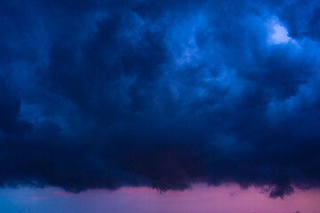 Naklejka na ściany i meble Stormy night sky. Huge rain cloud close up