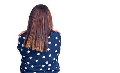 Young plus size woman wearing casual clothes hugging oneself happy and positive from backwards....