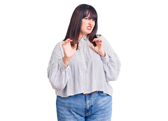 Young plus size woman wearing casual clothes disgusted expression, displeased and fearful doing disgust face because aversion reaction. with hands raised