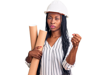 Young african american woman wearing architect hardhat holding blueprints annoyed and frustrated shouting with anger, yelling crazy with anger and hand raised