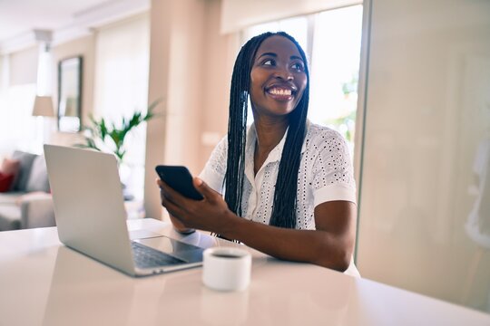 Young african american woman smiling happy working using laptop at home