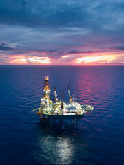 Aerial view from a drone of an offshore jack up rig at the offshore location during twilight time