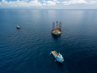 Offshore jack up rig and tow vessels during the rig move operation at the offshore location