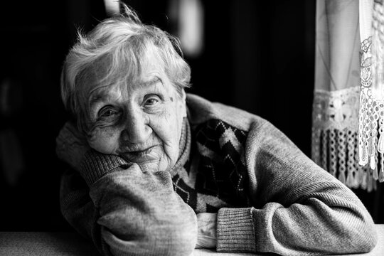 Close-up portrait of an elderly woman. Black and white photography.