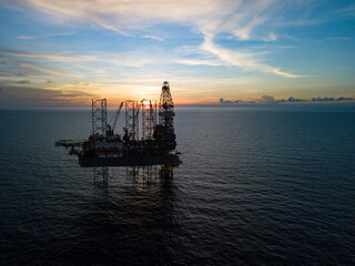 Aerial view from a drone of an offshore jack up rig at the offshore location during sunset time