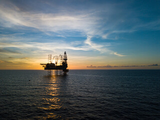 Fototapeta na wymiar Aerial view from a drone of an offshore jack up rig at the offshore location during sunset time