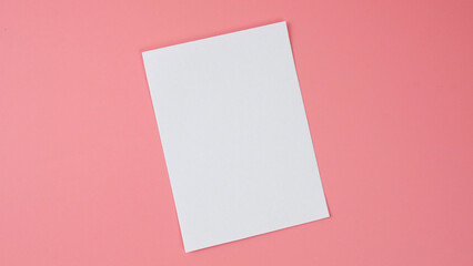 Obraz na płótnie Canvas White blank paper isolated on pink background, Top view Copy space for your text.