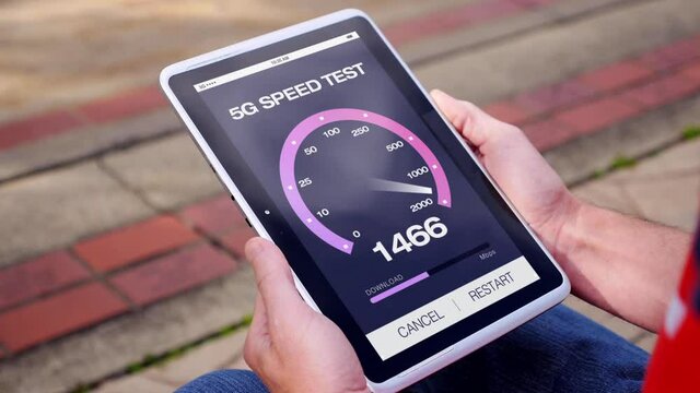 A man test his 5G wireless download speed on his tablet PC.  	