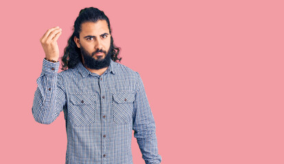 Young arab man wearing casual clothes doing italian gesture with hand and fingers confident expression