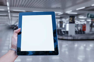 Mock up Tablet in hand closeup on airport background. Concept on the theme of air travel.