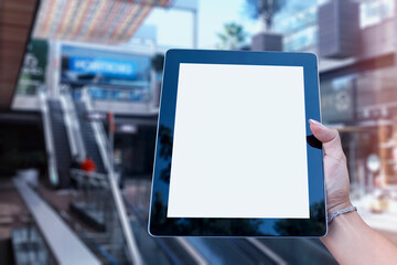Mock up Tablet in hand closeup on airport background. Concept on the theme of air travel.