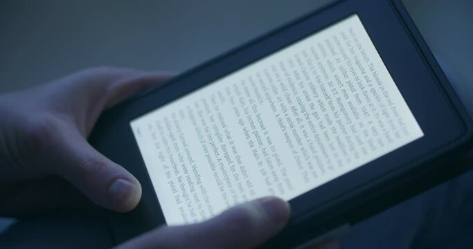 A woman reading an e-book in the evening or by night.