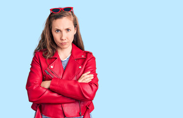 Young beautiful blonde woman wearing casual leather jacket skeptic and nervous, disapproving...