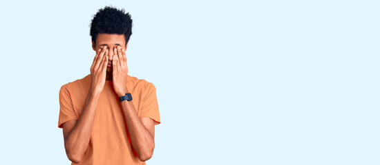 Fototapeta premium Young african american man wearing casual clothes rubbing eyes for fatigue and headache, sleepy and tired expression. vision problem