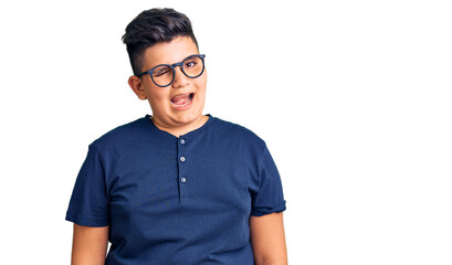Fototapeta premium Little boy kid wearing casual clothes and glasses winking looking at the camera with sexy expression, cheerful and happy face.