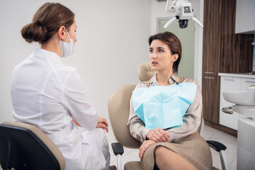 Young brunette woman on a check up at the dentistry office.