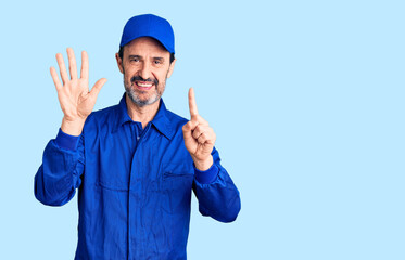 Middle age handsome man wearing mechanic uniform showing and pointing up with fingers number six while smiling confident and happy.