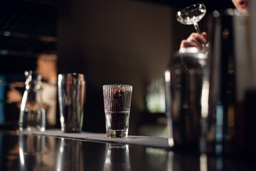 glass with flower buds for decorating cocktails on the bar close up.