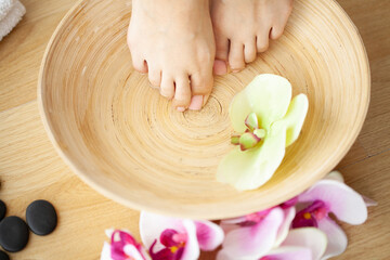 Fototapeta na wymiar Closeup photo of a female feet at spa salon on pedicure procedure