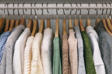 Clothes on a rail in a wardrobe. Seasonal capsule for easy dressing, order in things, cleaning out