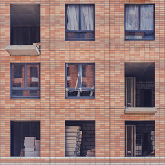 Facade with windows of an unfinished building, closeup house