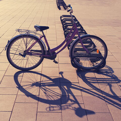Naklejka na ściany i meble Bike shadow on parking at sunset in the evening