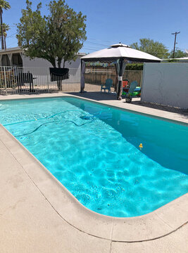 A self-propelled pool cleaner - also called a creeper cleans a bakcyard pool in Tucson Arizona