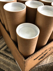 Recycled cardboard mailer tubes with white plastic end caps