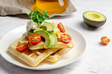 Fototapeta na wymiar Vegan waffles with avocado with yogurt and cherry