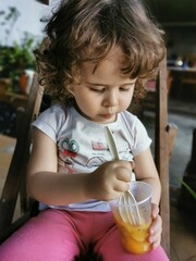 Portrait of a little girl eating some fruits