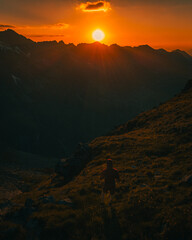 Silhouette of a lonely hiker in the mountains at sunset