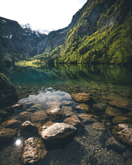 Fototapeta na wymiar Obersee Lake autumn landscape. Stone in crystal water in Berchtesgaden National Park