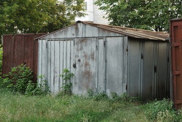 one gray old iron garage standing on a city street