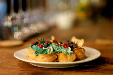Traditional french eclairs on white plate close up