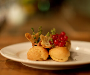 Traditional french eclairs on white plate close up