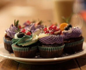several cupcakes with fresh berries - currants and blueberries, close up