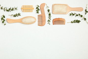 Flat lay composition with modern hair combs and brushes on white background. Space for text