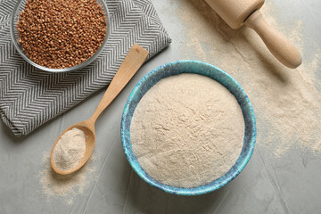 Flat lay composition with buckwheat flour on grey table