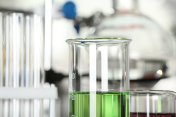 Glass beaker with liquid sample, closeup. Laboratory analysis