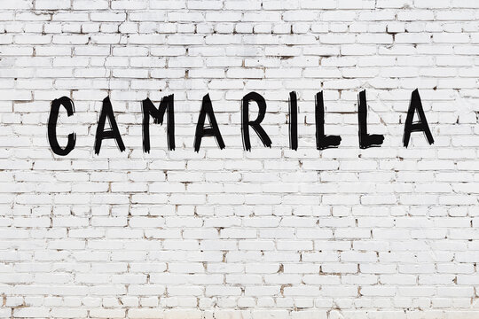 Inscription camarilla painted on white brick wall