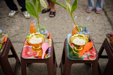 Kanchanaburi, Thailand - 6 August 2020: Food and utensils For giving to monks at the Mon Bridge in...