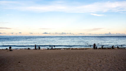 Fototapeta na wymiar Beach coast line with sea horizon view with people swimming