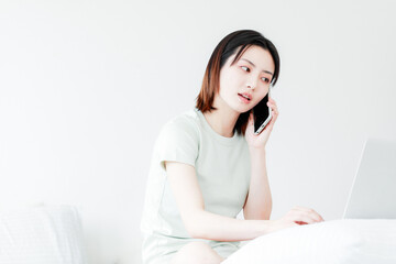 Women use mobile devices at home

