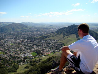 Man overlooking mountain and valley, San Luis Obispo