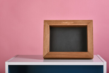 Picture wooden frame and cupboard on pink background, Photo frame with copyspace