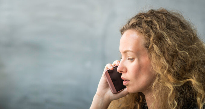 Caucasian female serious talking on the phone. moody woman having argument with friend, boyfriend or customer. connection with people via smartphone. isolated background with copy space