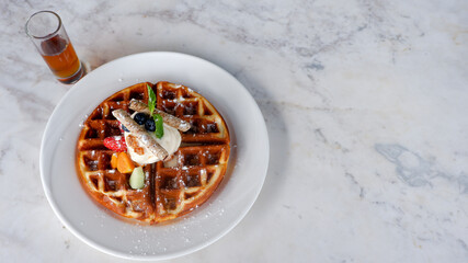 Fruit waffles with berries and ice cream