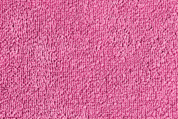 Pink towel texture. Macro fiber pattern. Soft cotton textile material background. Absorbent fluffy cloth.